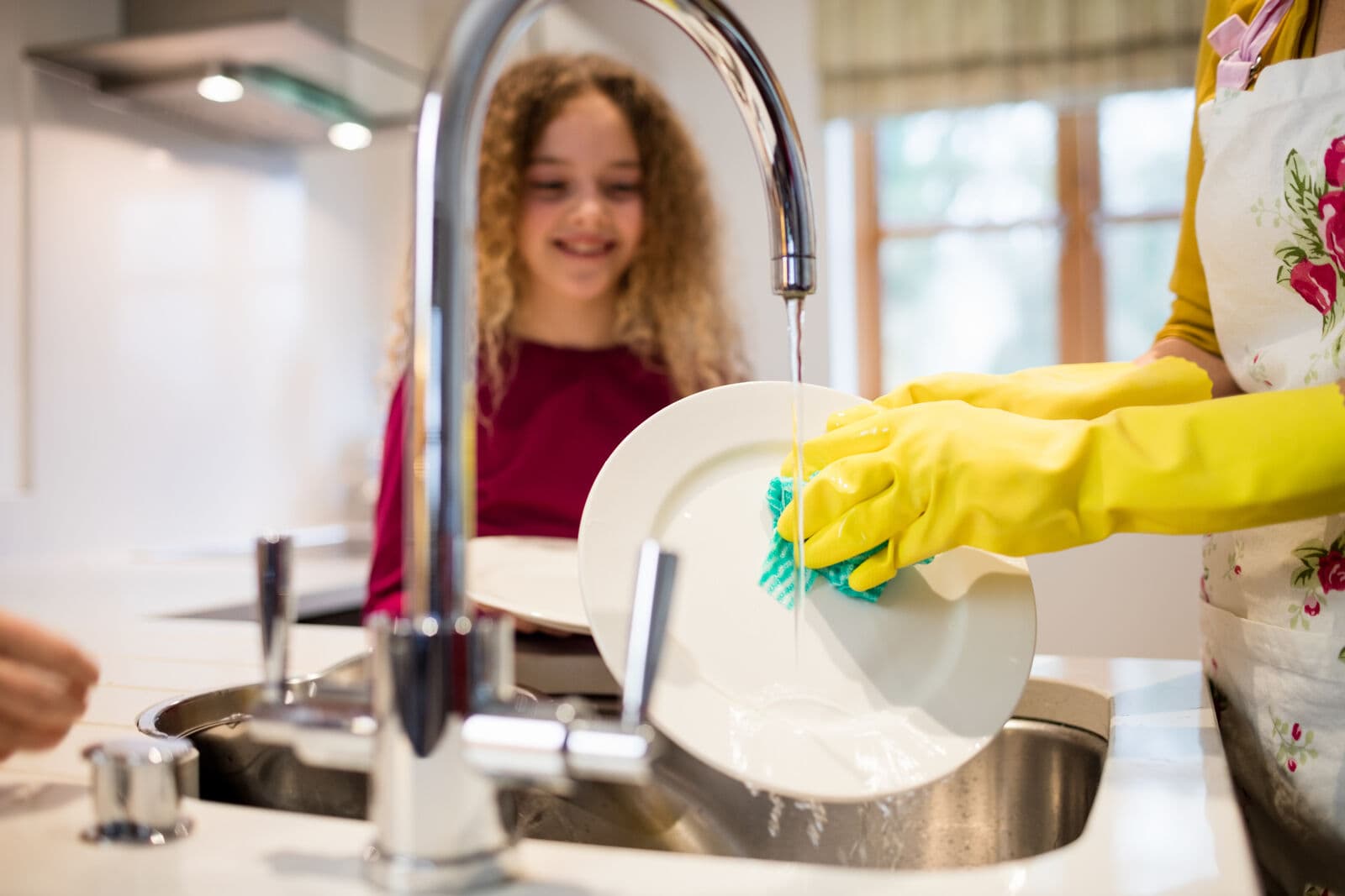 Family washing dishes with clean filtered water