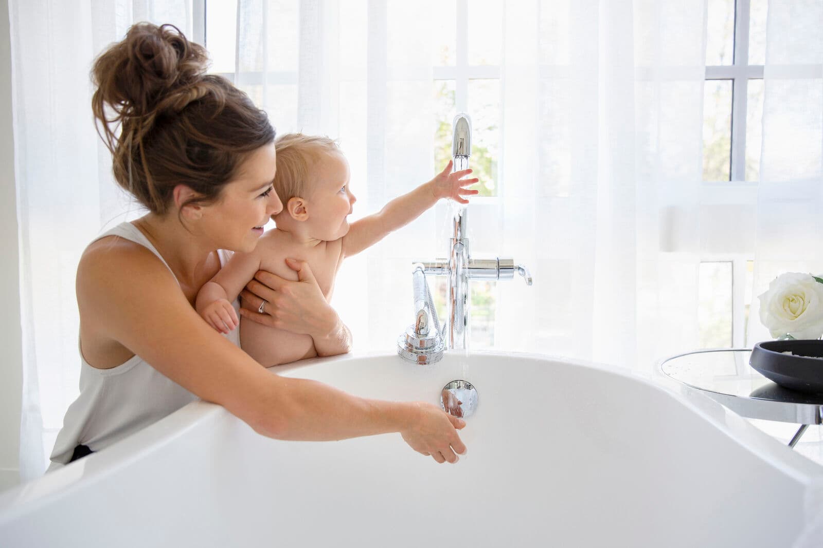 Mother and baby enjoying clean bath water
